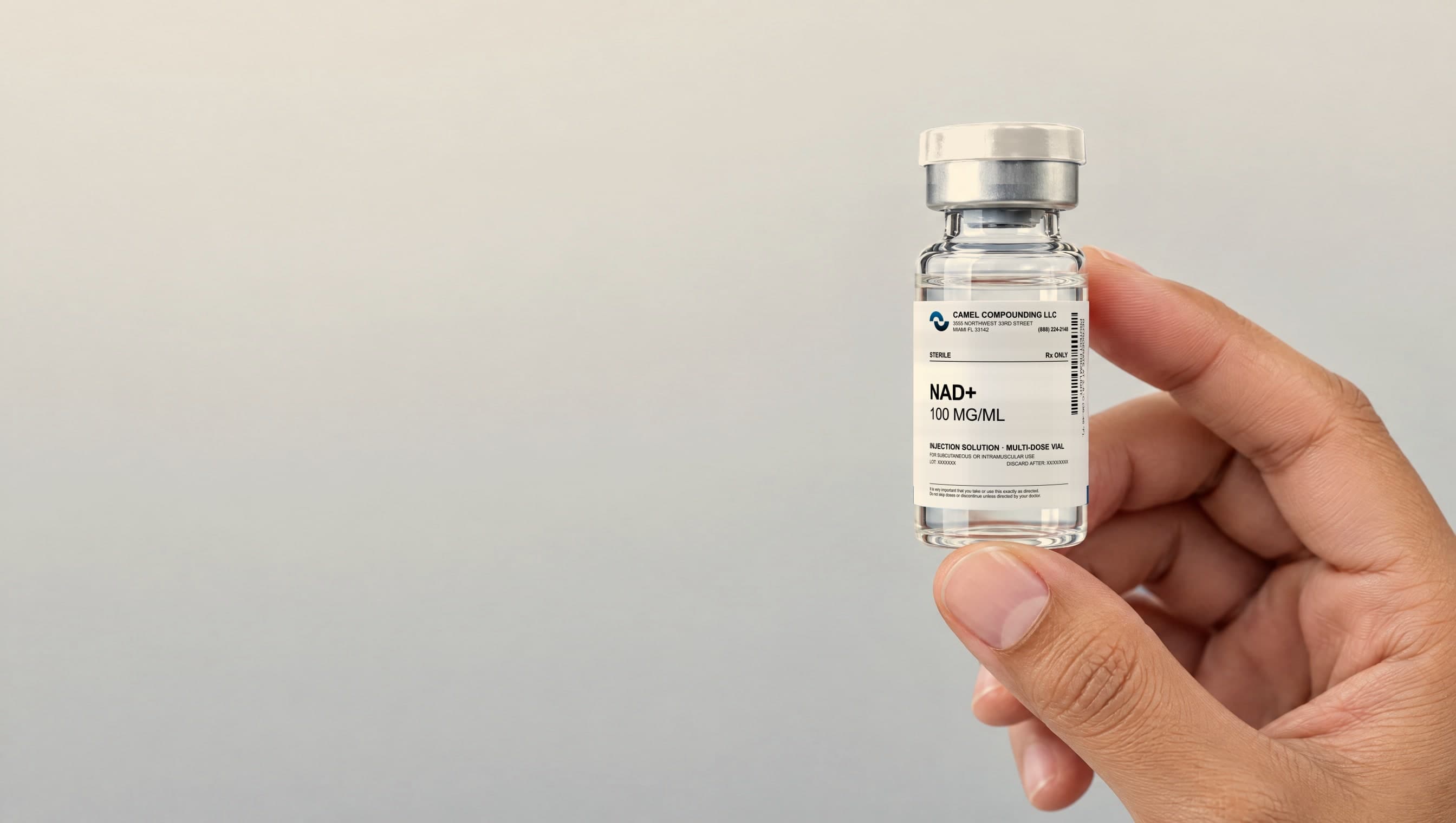 Hand holding a Camel Compounding sterile injectable vial